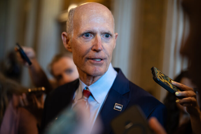rick-scott-says-he’s-just-trying-to-help